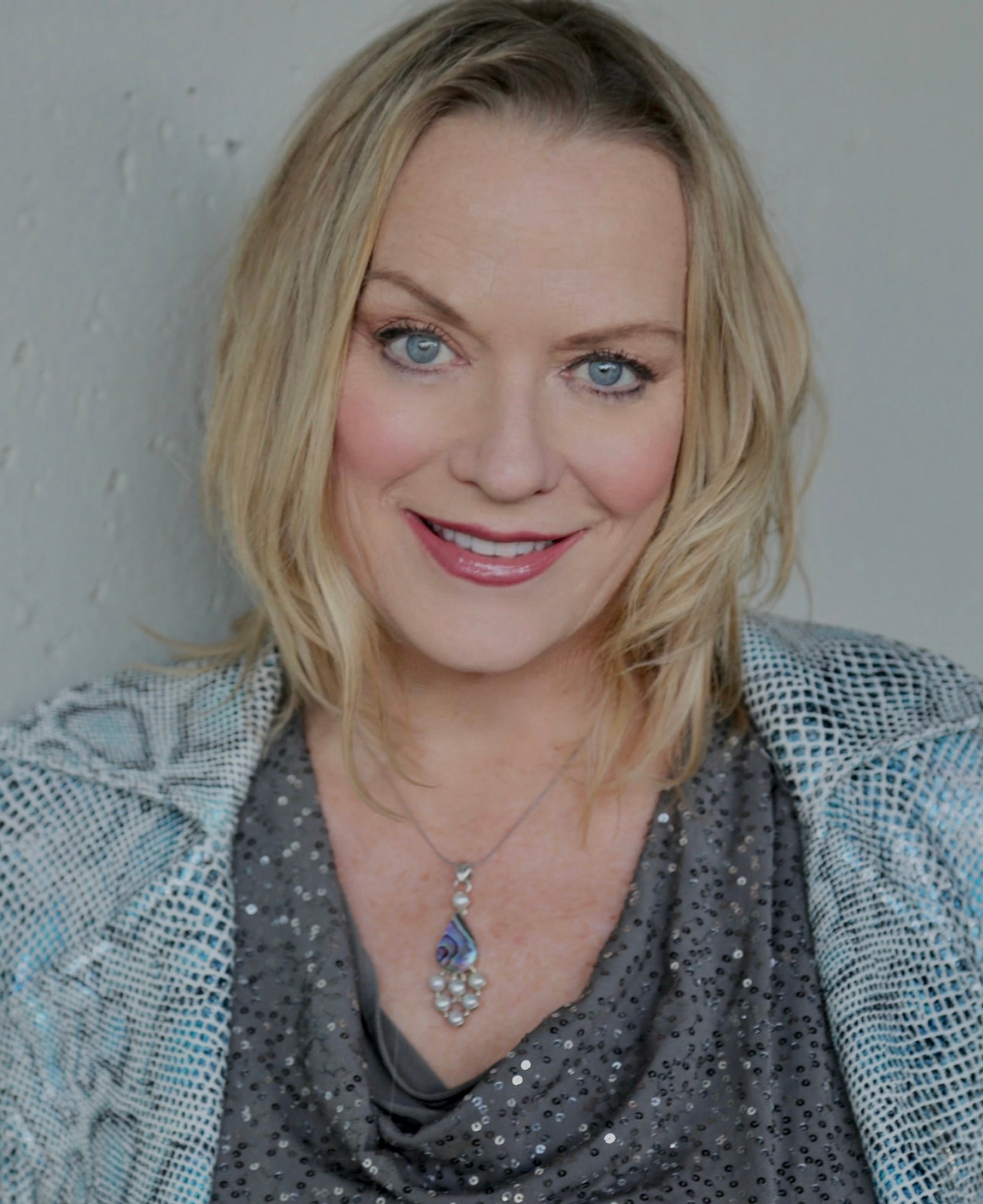 Tess Cacciatore, creator of Yumi's Universe, smiling in a head-and-shoulders portrait